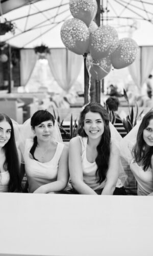Group of six girls sitting at table on hen party, with balloons. Group of six girls sitting at table on hen party, with balloons.