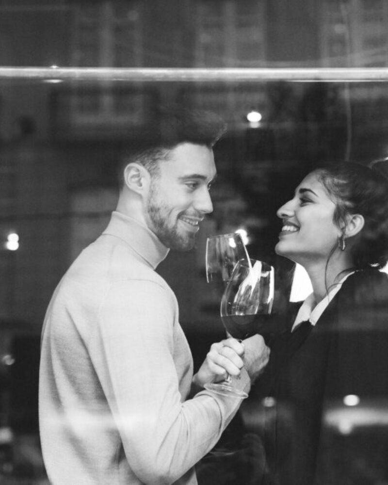 smiling-man-woman-holding-glasses-wine-restaurant